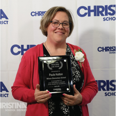Photo of Paula Hutton Wilson ES Teacher of the Year holding plaque